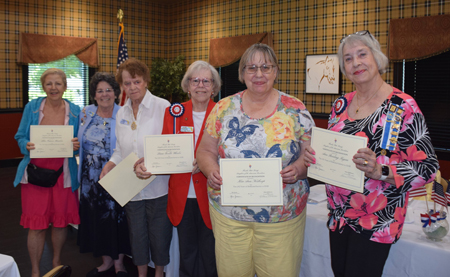 lineup of 6 women with certificates